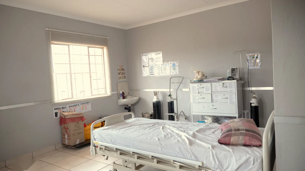 A patient bed and medical equipment in a bright clinic ward