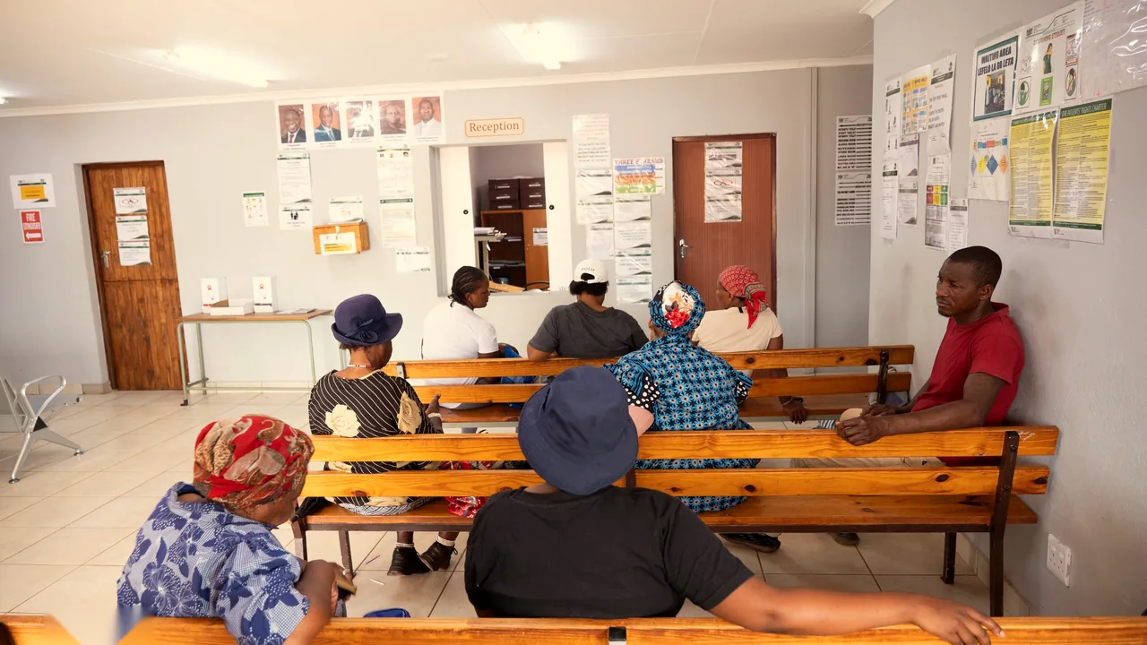 Patients waiting on benches in the clinic reception