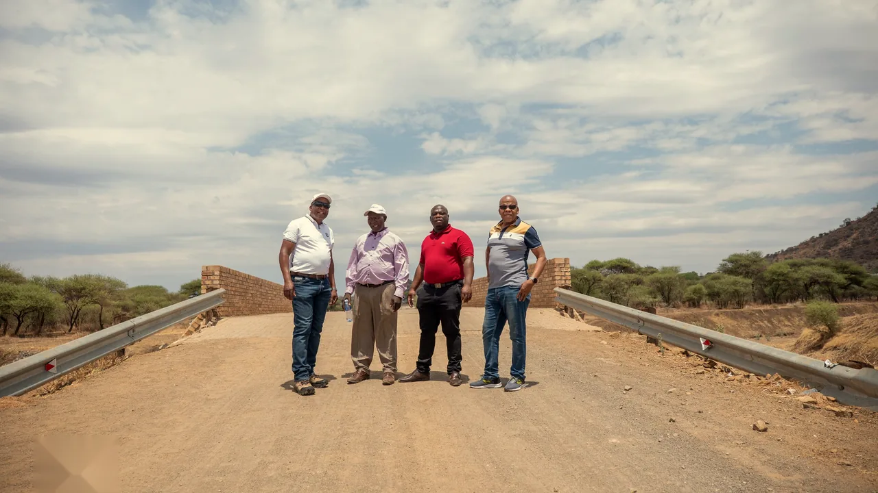 Four community and Trust representatives standing on the new bridge